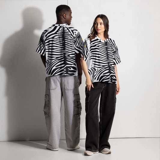 Models wearing black and white zebra patterned oversized tops with gray and black pants, showcasing relaxed urban fashion.