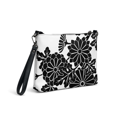Stylish Umhängetasche N°1 with floral design, black and white pattern, and detachable wrist strap ideal for versatile use.