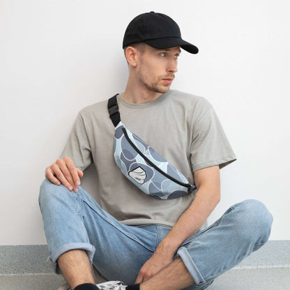 Man wearing Gürteltasche N°31 crossbody bag, sitting on floor in casual outfit, showcasing adjustable strap and modern design.