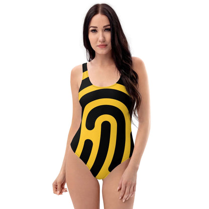 Model wearing Einteiliger Badeanzug N°20 in bold black and yellow pattern, flattering fit, front view.