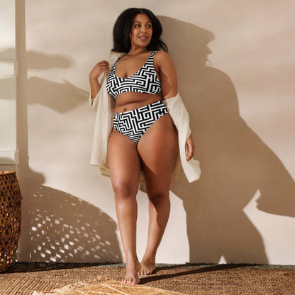 Model wearing Recycelter Allover High Waist Bikini N°2 with geometric pattern, standing confidently in sunlight with a cover-up.