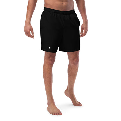 Model wearing Herren-Badehosen N°11, quick-drying black swim shorts with pockets, demonstrating breathable and comfortable design.