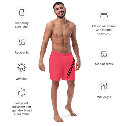 Man wearing Herren-Badehosen N°13, red color, highlighting features like elastic waistband, side pockets, and recycled polyester fabric.