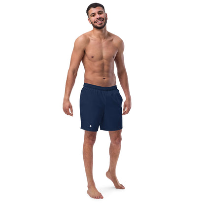 Smiling man wearing Herren-Badehosen N°16, displaying quick-dry, breathable swimwear with pockets and silky lining, navy blue color.