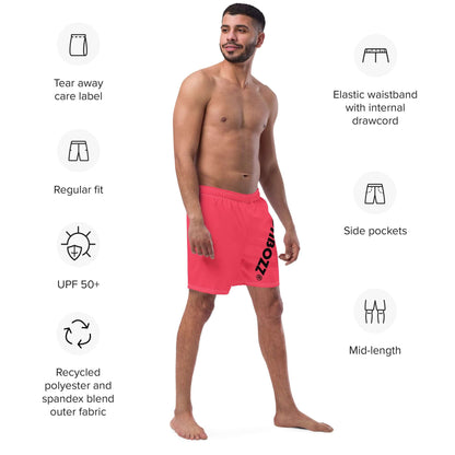 Man wearing Herren-Badehosen N°13 in red, featuring tear away label, elastic waistband, side pockets, and UPF 50+ protection.