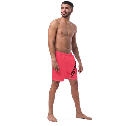 Man wearing Herren-Badehosen N°13 in pink, featuring quick-dry and breathable fabric with pockets and silky lining for comfort.