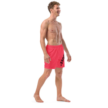 Man wearing Herren-Badehosen N°13, quick-dry red swim trunks with pockets and silky lining, designed for summer comfort.