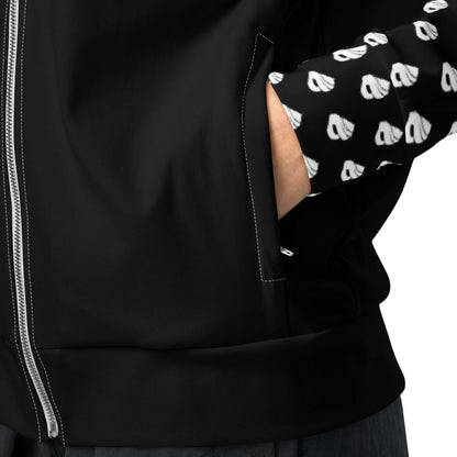 Close-up of person wearing black Unisex-Trainingsjacke N°0 with zipper and patterned sleeve, hand in pocket, showcasing style and warmth.