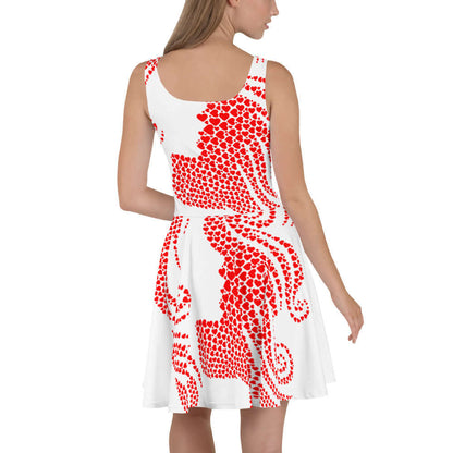 Woman wearing sleeveless Skater-Kleid N°7 with red and white heart pattern, showcasing its elegant, flared design and elastic waist.