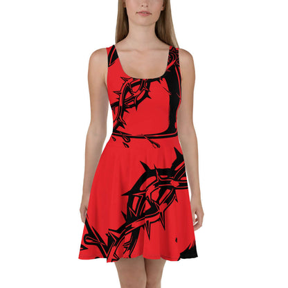 Frau trägt Skater-Kleid N°8, ärmelloses Design, rotes und schwarzes Muster, eleganter, ausgestellter Rock als modisches Statement.