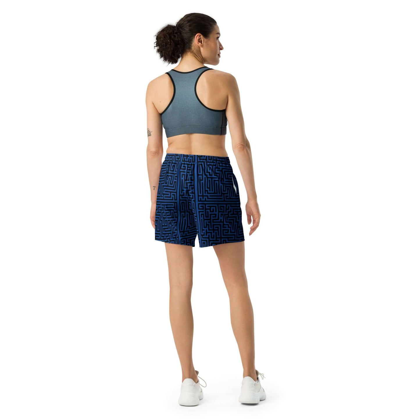 Back view of a woman wearing Lange Unisex Sport-Shorts for versatile athletic activities.
