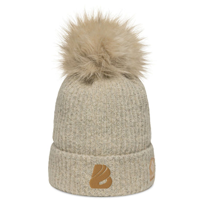 Columbia Bommelmütze in Beige mit flauschigem Kunstfaser-Bommel und weichem Mikrofleece-Futter, perfekt für Wintertage.
