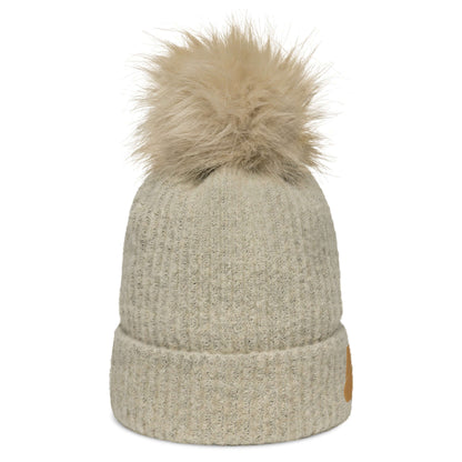 Columbia Bommelmütze with soft faux fur pom-pom, warm acrylic-knitted design, and cozy polyester fleece lining for stylish winter wear.