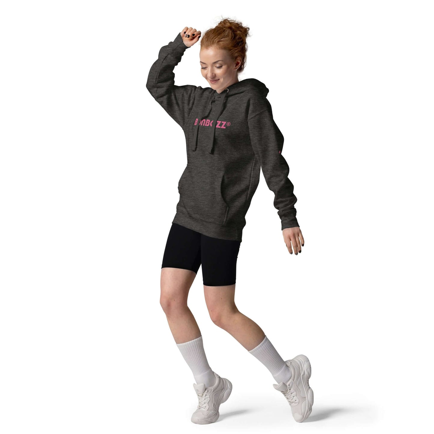 Unisex-Kapuzenpullover in dark grey worn by a person dancing, featuring front kangaroo pocket and warm hood.
