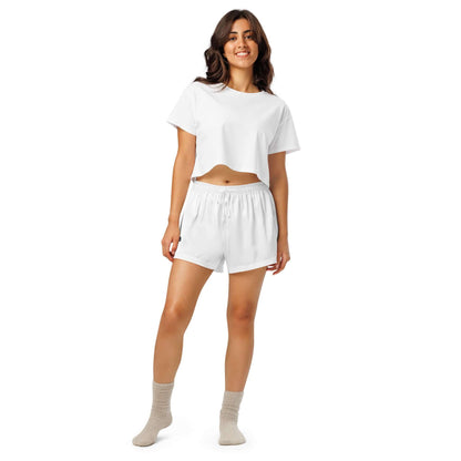 Woman wearing white Pyjama-Shorts für Damen with socks, ideal for relaxing or lounging, showcasing elegant casual style.