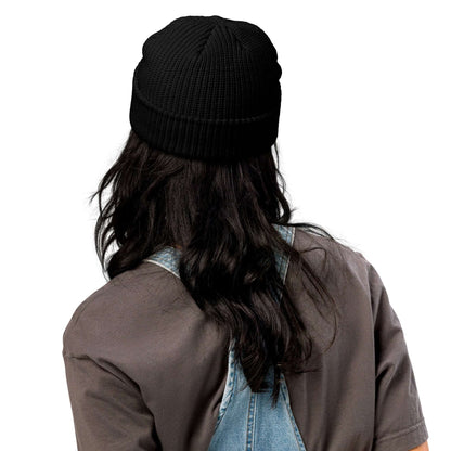 Person wearing Fischermütze N°0, a black ribbed beanie styled for warmth and fashion, perfect for versatile outfits, made of 100% acrylic.