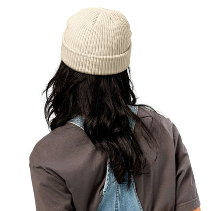 Person wearing Fischermütze N°0 beanie, cream color, showcasing trendy fisherman style and ribbed knit texture. Perfect for cold weather.