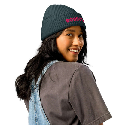 Woman wearing Fischermütze N°0 beanie, trendy ribbed knit hat for cold weather, versatile fashion in green color.