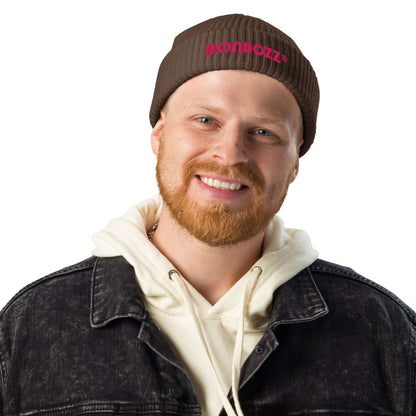 Man wearing Fischermütze N°0, stylish brown beanie, paired with a black denim jacket and white hoodie, showcasing trendy fisherman style.