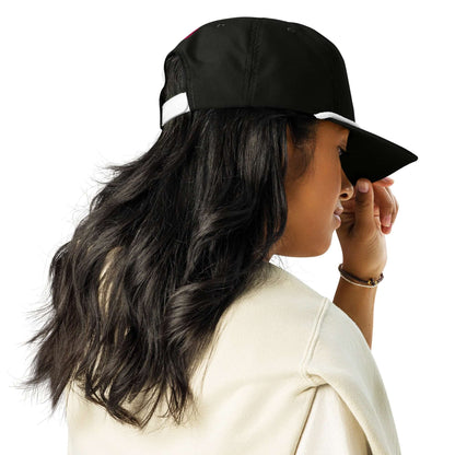 Woman wearing black Golfcap with structured fit and snapback closure, adding classic style to her outfit.