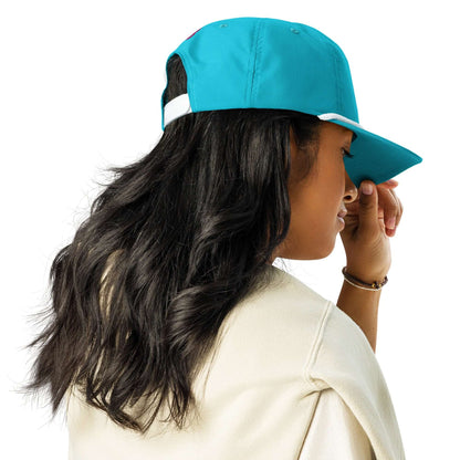 Person wearing a blue Golfcap with a snapback closure, showcasing a classic style with long hair flowing down the back.