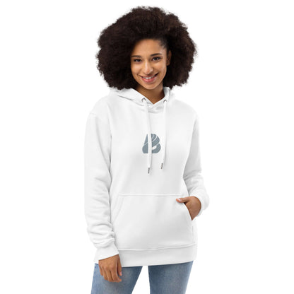Woman wearing Hochwertiger Öko Kapuzenpullover N°15 in white, featuring a stylish design with front pocket and double-layered hood.