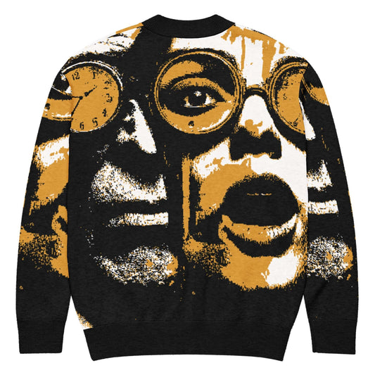 Kreativer Strickjacke mit einzigartigem grafischen Muster, das Gesichter und Uhren in Schwarz und Orange darstellt.