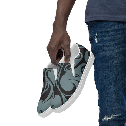 Person holding Herren-Canvas-Slipper N°2, featuring stylish design, removable insoles, and lightweight comfort with EVA rubber soles.