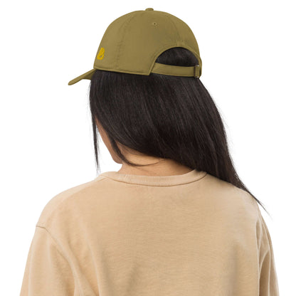 Back view of person wearing olive Bio-Dad Hat N°1 made from organic cotton, highlighting sustainable fashion.