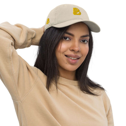Woman wearing Bio-Dad Hat N°1 made from 100% organic cotton, unstructured 6-panel design, eco-friendly fashion accessory.