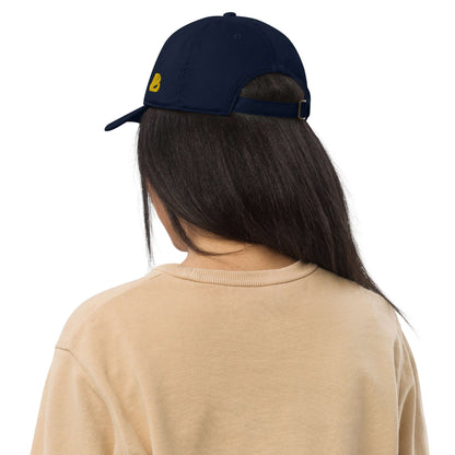 Back view of a person wearing a navy blue Bio-Dad Hat N°1 made from 100% organic cotton, showcasing the adjustable strap.