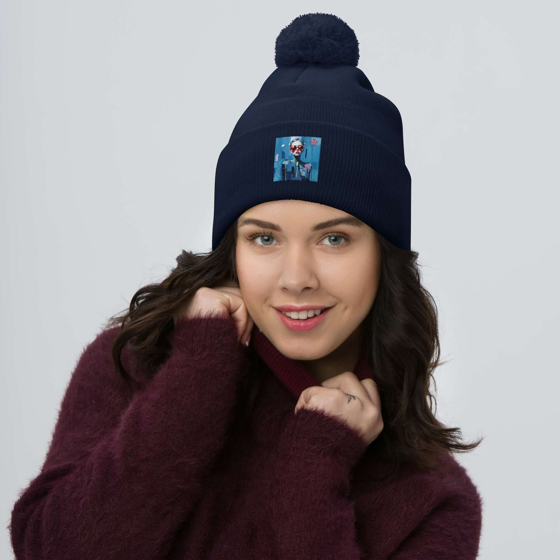 Woman wearing a dark blue Bommelmütze with pom-pom, embroidered design, cozy winter fashion accessory