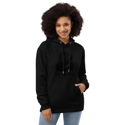 Woman wearing Hochwertiger Öko Kapuzenpullover N°13 in black, made from organic cotton and recycled polyester, with a front pocket.