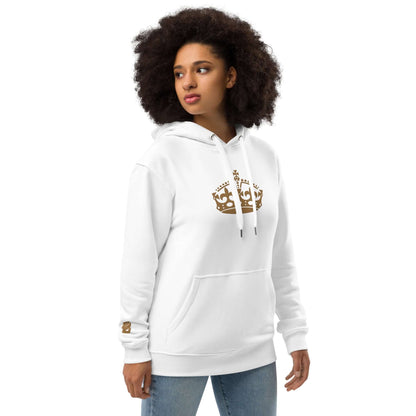 Woman wearing white hoodie with crown design, hands in pocket, showing front view.