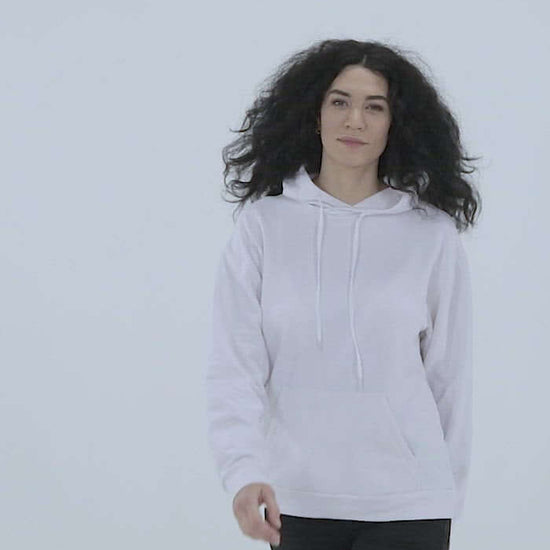Woman wearing Unisex-Kapuzenpullover N°3, showcasing soft white fabric and relaxed fit against a minimalist background.