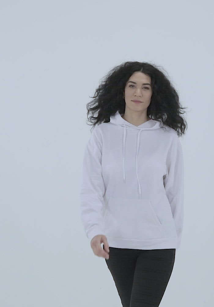 Woman wearing Unisex-Kapuzenpullover N°3, showcasing soft white fabric and relaxed fit against a minimalist background.