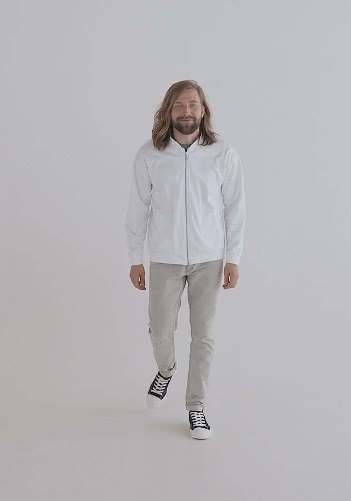 Model wearing white Unisex Bomberjacke N°2, showcasing versatile fashion and comfort with fleece inside and unisex fit.