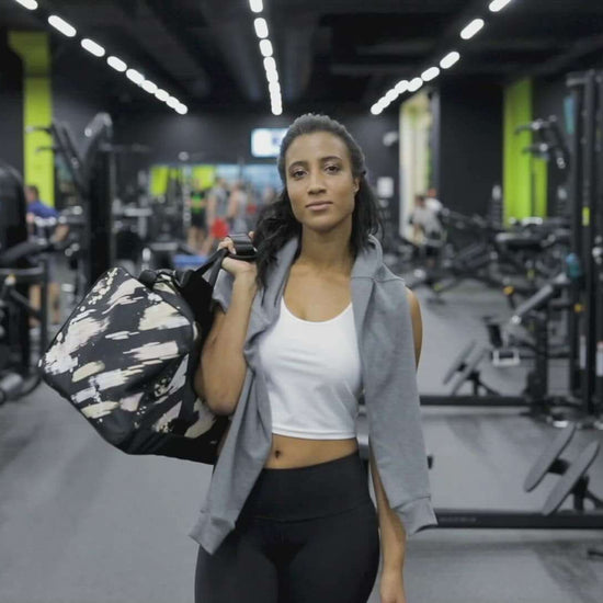 Woman carrying Weekender N°0 bag in gym setting for versatile use