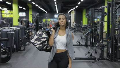Person carrying a Weekender N°0 bag in a gym setting, showcasing versatile use for travel, errands, or fitness. Spacious with multiple pockets.
