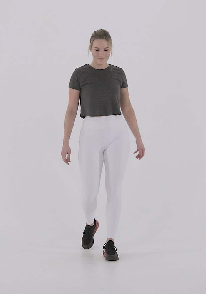 Person wearing white Yoga-Leggings N°3 with high waist, demonstrating stretch and comfort in active pose.