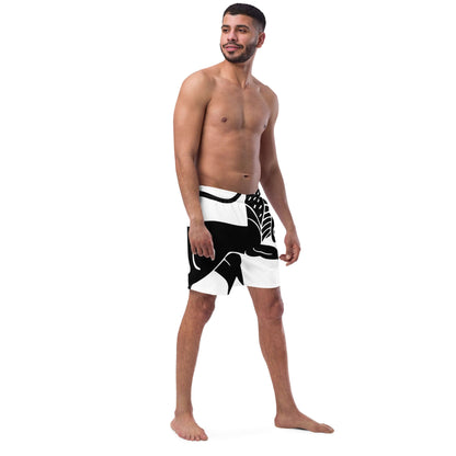 Model wearing black and white Recycelte Schwimmshorts with a tropical pattern, perfect for summer with quick-dry and breathable features.
