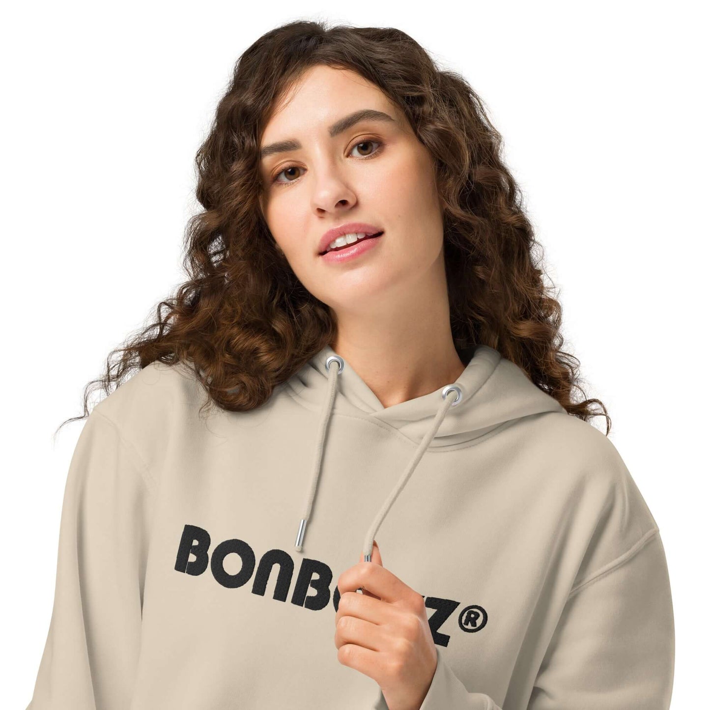 Unisex bio-hoodie in light beige featuring 'BONBOZZ' logo, model showcasing streetwear style.