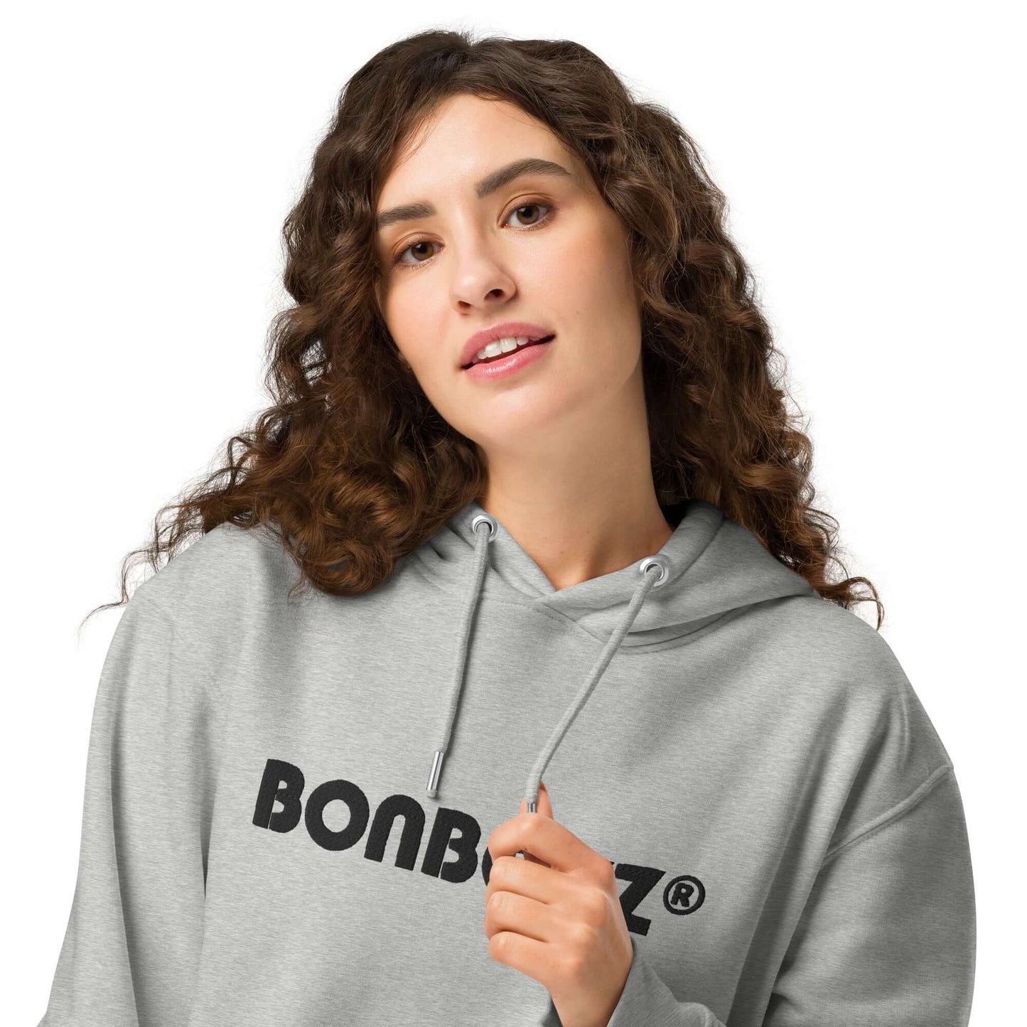 Model wearing a unisex bio-hoodie made from eco-friendly materials in gray with a bold logo.