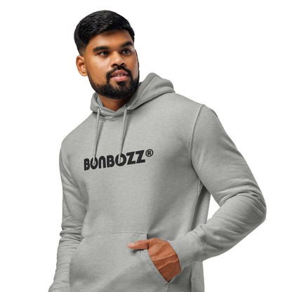 Man wearing a grey Unisex Bio-Hoodie with a logo in front, featuring eco-friendly and recycled materials for a chic streetwear look.