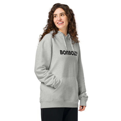 Woman wearing a grey Unisex Bio-Hoodie with kangaroo pocket, made from organic cotton and recycled polyester.