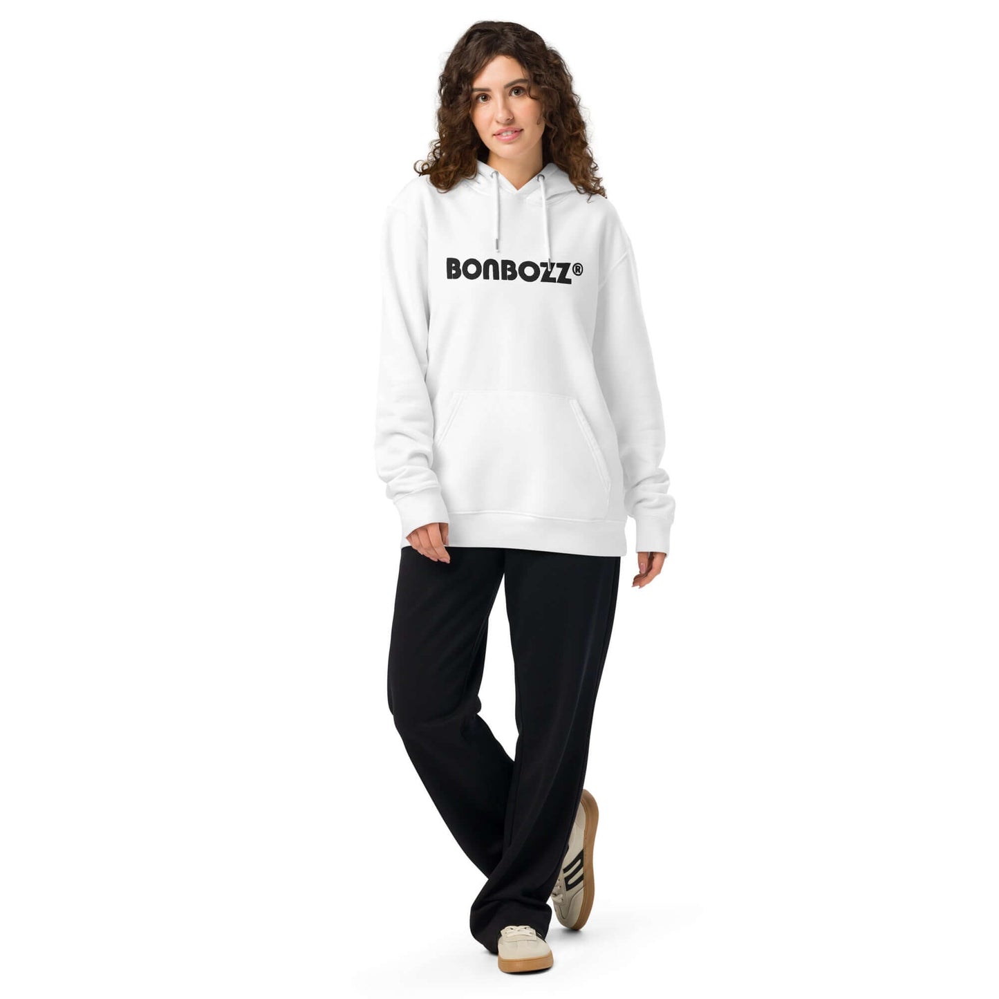 Unisex white bio-hoodie with logo, paired with black pants for a stylish streetwear look.
