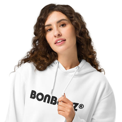 Model wearing Unisex Bio-Hoodie in white with eco-friendly materials, featuring double-layer hood and kangaroo pocket.