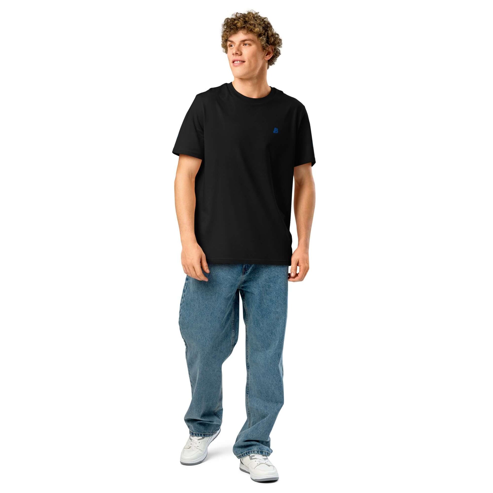 Model wearing a black unisex bio T-shirt with a structured ribbed collar and casual jeans.
