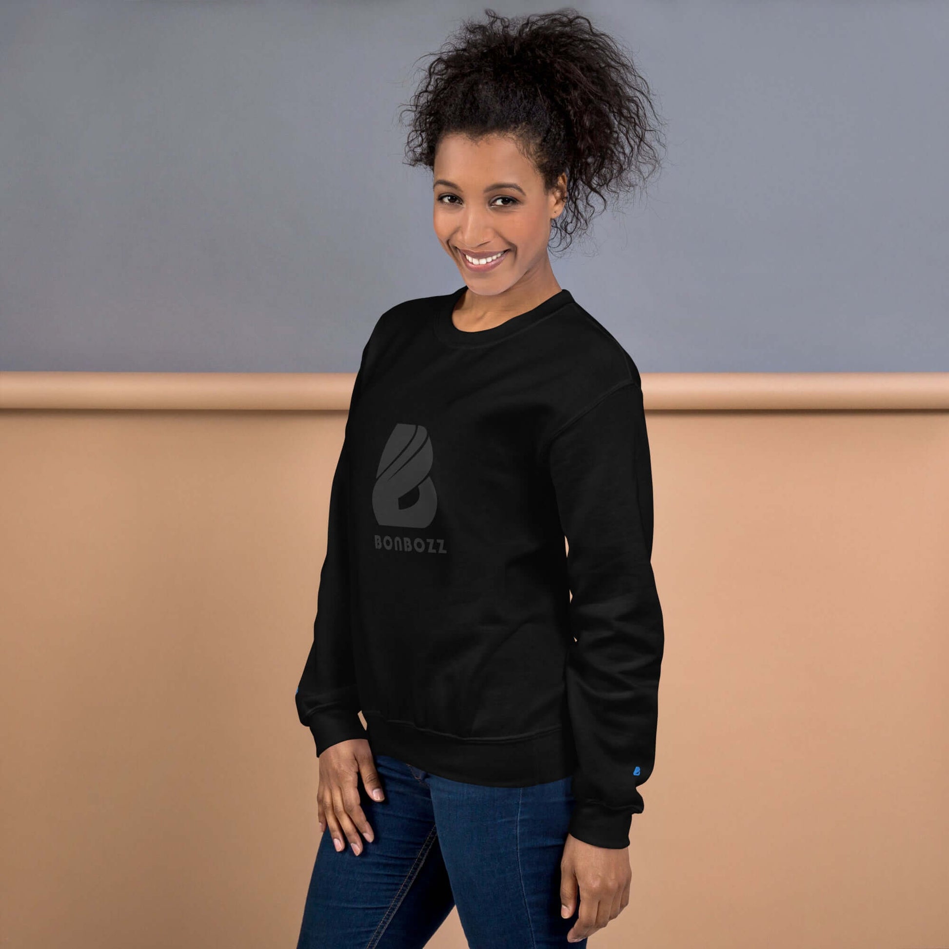 Woman wearing Unisex-Pullover, black sweatshirt, showcasing robust warm design, made from 50% cotton and 50% polyester, classic fit.