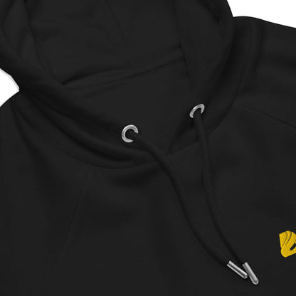 Close-up of black Unisex Bio-Raglan-Hoodie N°5 with drawstrings and yellow stitching detail.